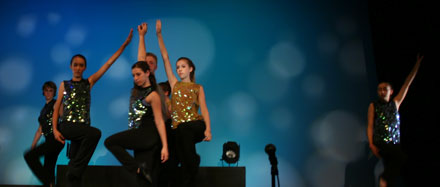 dancers perform at summer arts camp against spotted cyc